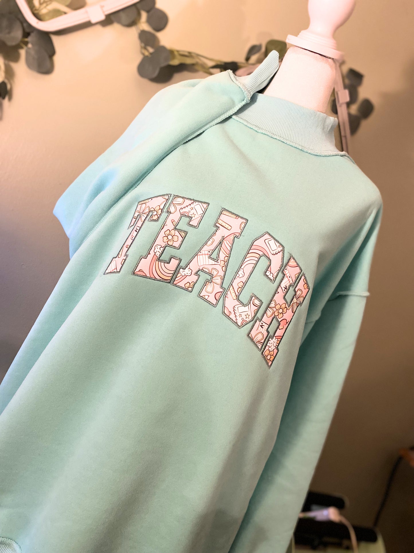 'Teach' Applique Embroidered Mockneck Sweatshirt