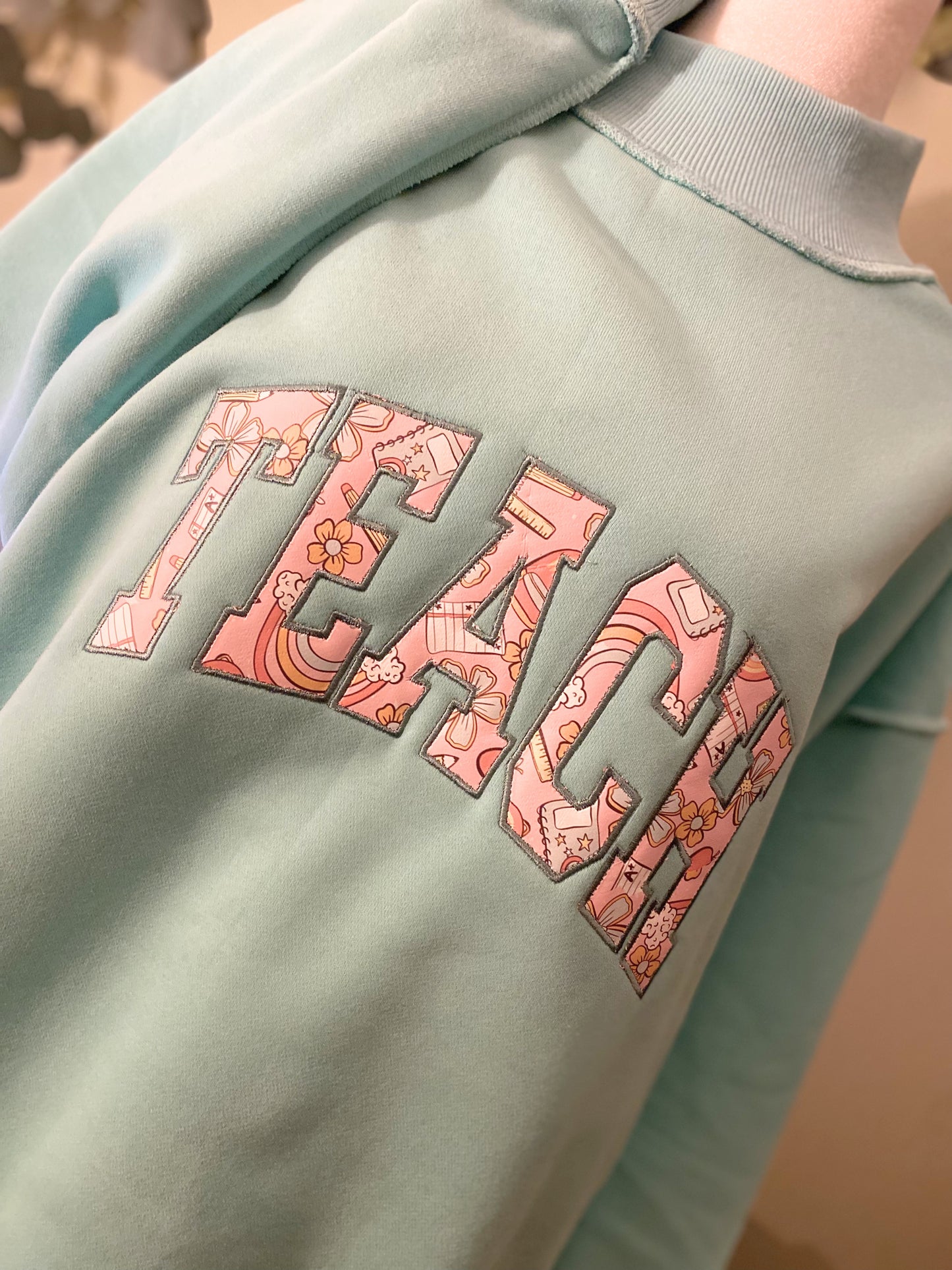 'Teach' Applique Embroidered Mockneck Sweatshirt